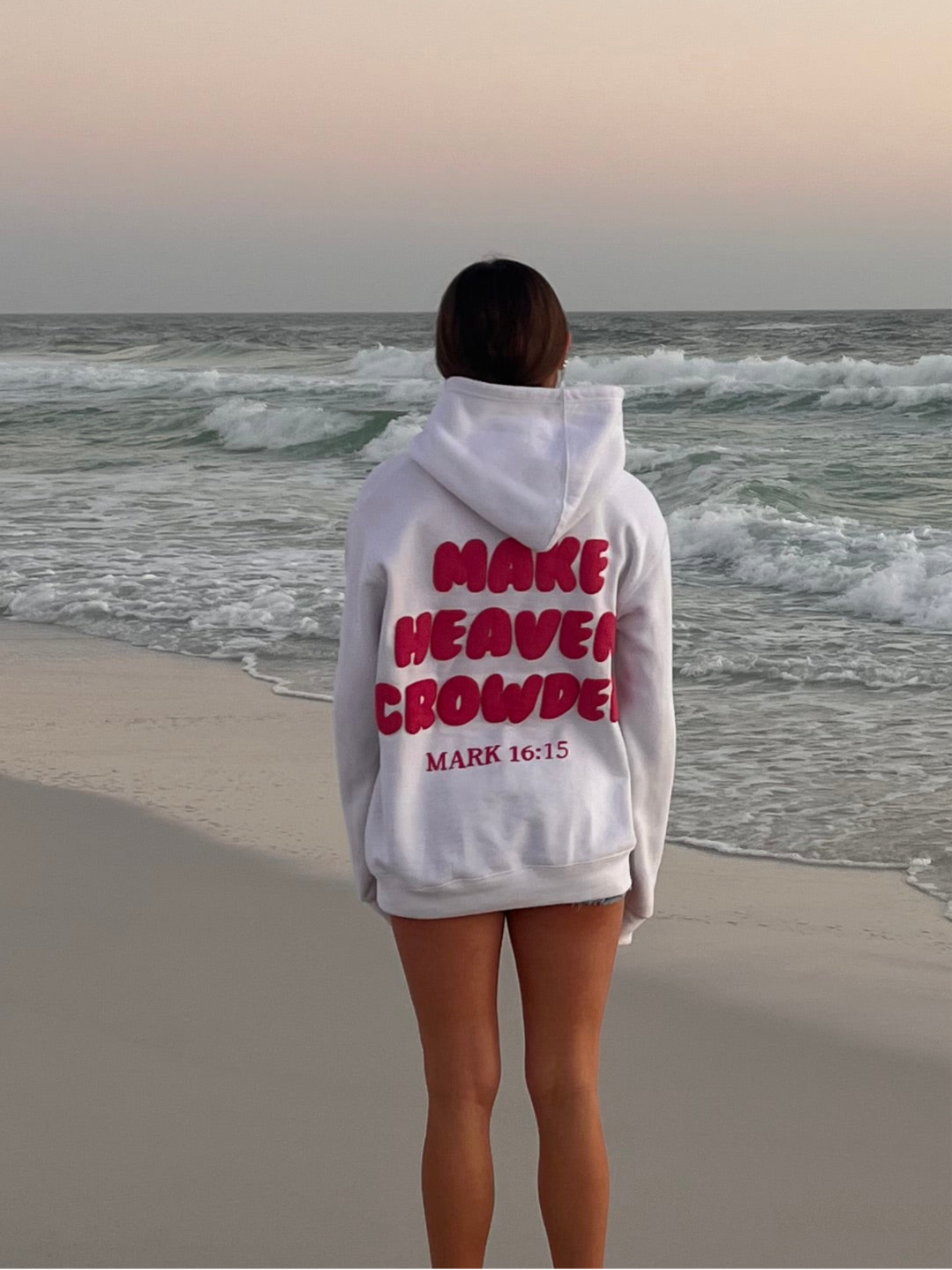Girl wearing Make Heaven Crowded Classic Puff Print Hoodie- White and Pink- Mark 16:15